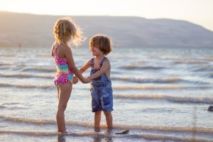 children playing on beach on holiday