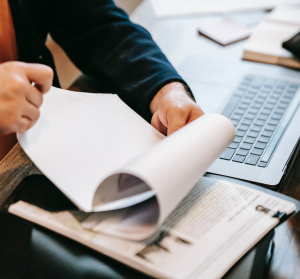 A man reviewing documents, flipping through the pages