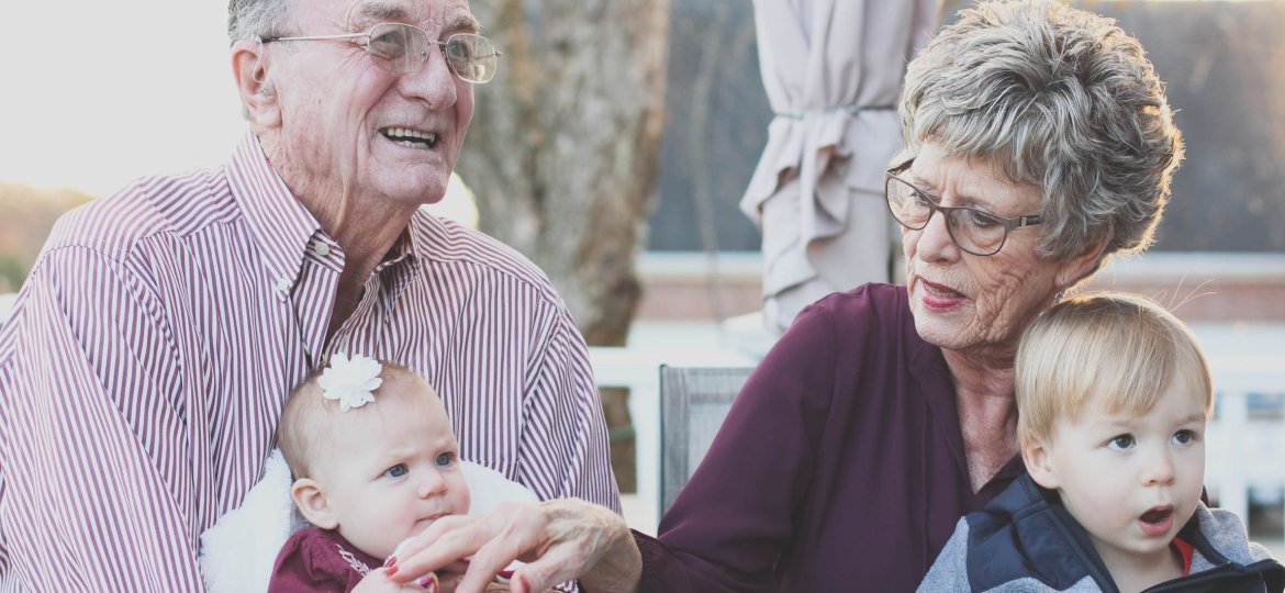 Grandparents holding grandchildren