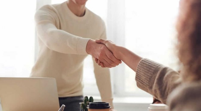 Man and Woman shaking hands over divorce facilitation.