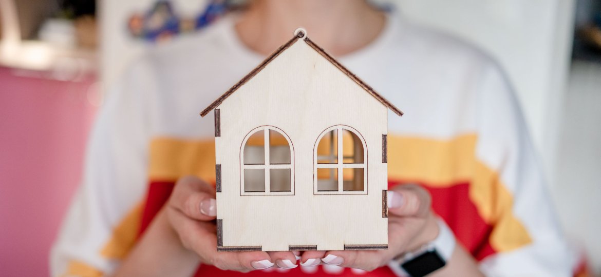holding wooden house