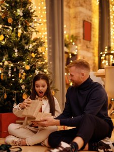 Little girl opening Christmas gift