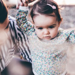 Chid holding parents hands