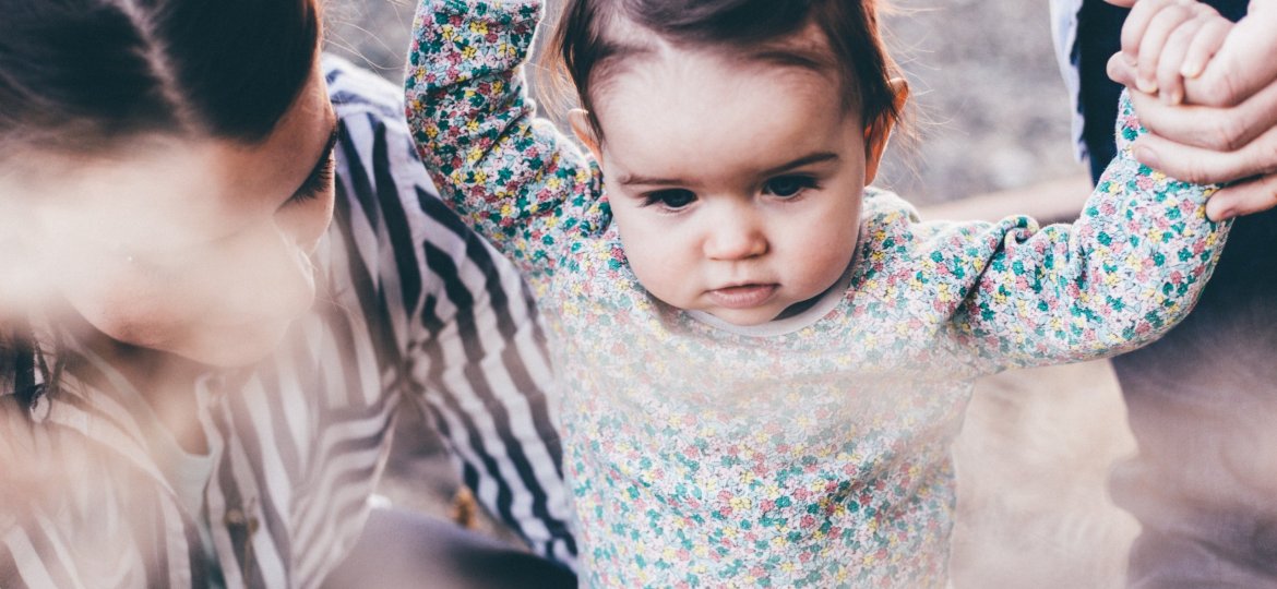 Chid holding parents hands