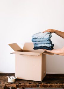 packing jeans into a box for moving