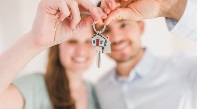 Couple holding house keys