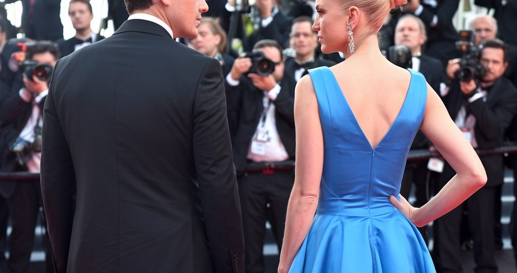 Celebrity Couple being photographed by paparazzi.