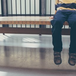 Child sitting on a bench