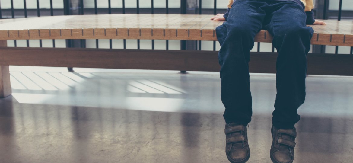 Child sitting on a bench