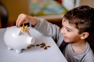 little boy with piggy bank
