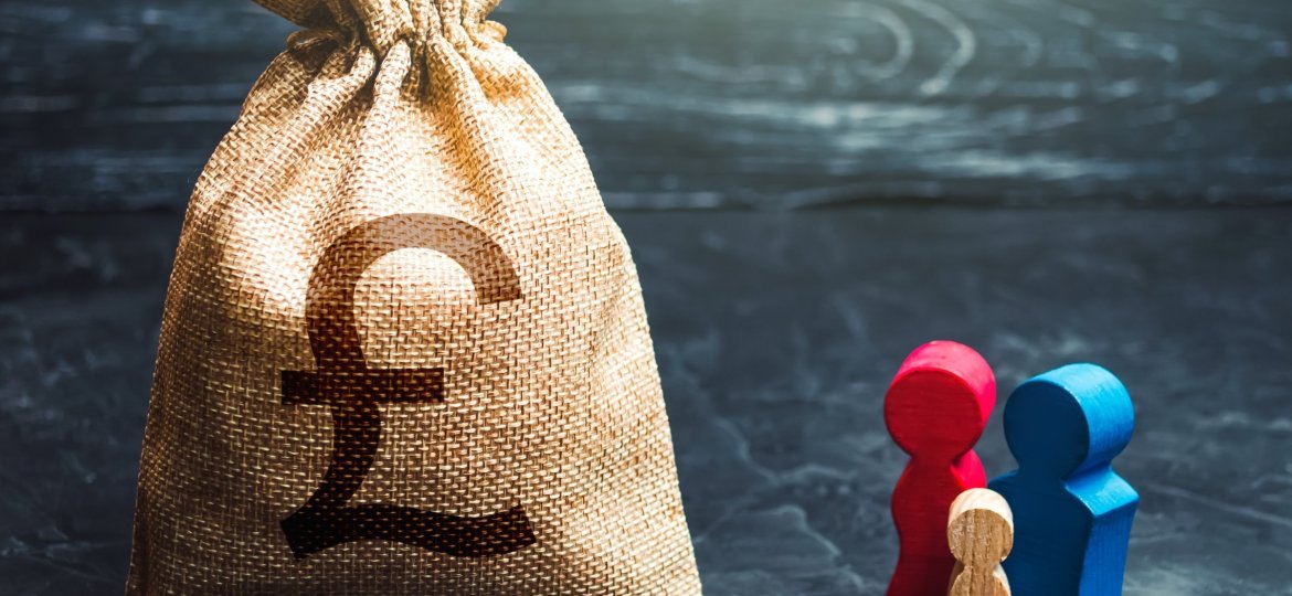 Family figurines and british pound sterling money bag.