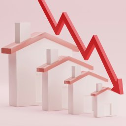 houses in a row with downward arrow indicating drop in value