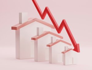 houses in a row with downward arrow indicating drop in value