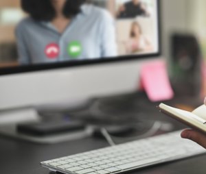 Man,Taking,Notes,Sitting,In,Front,His,Computer on a meeting