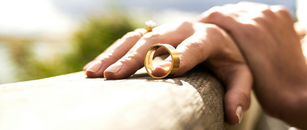 woman hands holiding her ex-husbands wedding ring