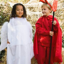 Little girl dressed as and angel and littl eboy dressed as a devil