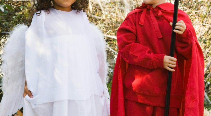 Little girl dressed as and angel and littl eboy dressed as a devil