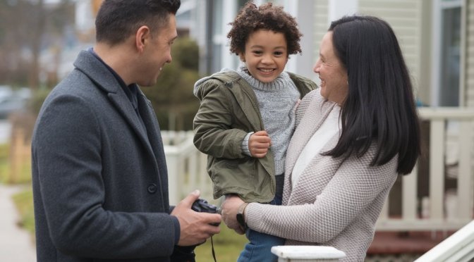 Separated Parents holding a small child